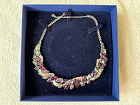 Necklace laid in box showing full design and extender chain