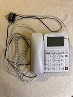Whole phone with handset, handset cord, line cord and power adapter visible