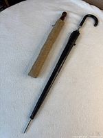 Two closed umbrellas in sleeves