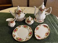 Full set view showing coffee pot, teapot, sugar, creamer, plates