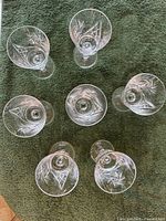 Top view of seven goblets showing cut patterns
