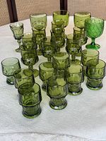 Entire assortment of green glasses showing tumblers, cordials and large goblet