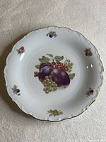 Front view showing fruit motif, rim sprigs, scalloped gold edge