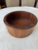 angled view of wooden bowl showing split on side