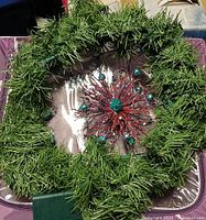 Full view of artificial pine wreath showing overall design and size
