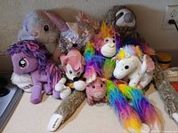 Group shot of all eight plush toys on countertop