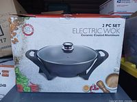 Front of box showing electric wok image and branding