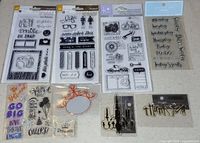 All ten stamp sets laid out showing contents and packaging