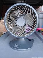 Front view of Holmes Blizzard table fan showing spiral grille and logo