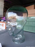 Front-left view of light green glass mannequin head
