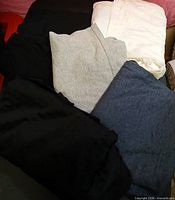 Stacked folded T-shirts showing assorted colors