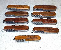 Front view of nine closed multi-tools showing location engravings