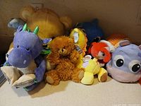 Group of assorted plush toys on counter