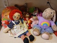 Group shot of all plush toys and cloth doll