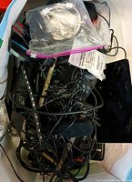 Bag containing tangled cables, adapters and electronics