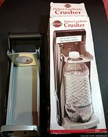 Crusher unit beside original retail box