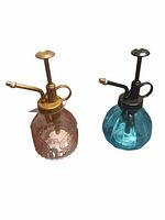 Front view of both glass plant misters showing colors and pump mechanisms