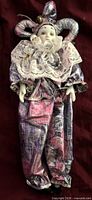 Full view of porcelain jester doll showing costume and overall form