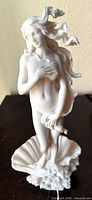 Front view of white bisque Venus figurine on shell base