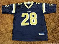 Front view of navy Reebok Rams #28 jersey
