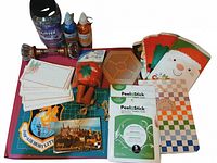 Overhead view showing entire assortment including adhesive packs, glitter, glitter glue, sticker book, gift bags, pincushion, door knobs, cutting mat, organizer and cards
