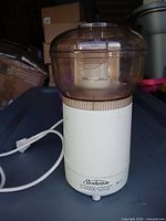 Front view of Sunbeam Oskar food processor showing branding, bowl, lid, power cord