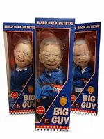 Front view of three boxed The Big Guy dolls