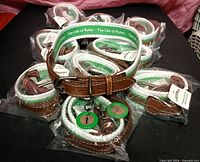 Ten packaged dog collars with one collar displayed on top showing buckle and tags