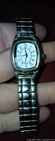 Front view of unbranded wristwatch held in hand