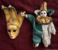 Mask and jester doll together displaying relative size and appearance