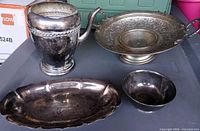 All four silver-plated pieces on table