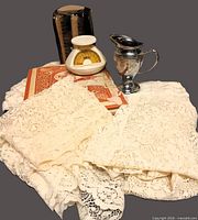 Group shot showing lace textiles, EKCO scale, creamer, yearbook