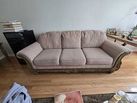 Front view of entire sofa showing upholstery and carved wood base