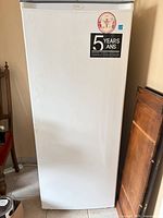 Front view of white Danby upright freezer