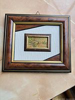 Front view showing framed miniature art and frame details