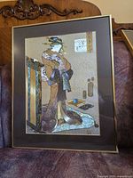 Framed Japanese art print of standing female figure in gold frame