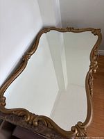 Full view of mirror atop table showing frame shape and mirror surface