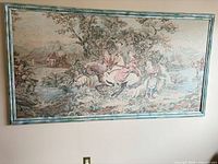 Full view of framed tapestry on wall
