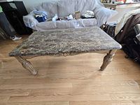 Full view of marble coffee table showing top and legs