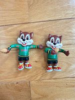 Front view of both Skippy figurines side by side showing size difference and one holding football
