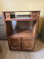 Front view of wooden TV stand with open shelf and closed cabinet