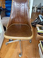 Front view of brown vinyl rolling chair