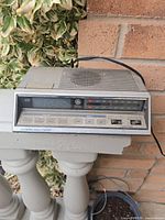 Front view of GE electronic touch control clock radio showing display, touch buttons and band indicators