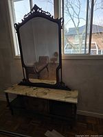 front view of vanity table with mirror against window