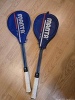 Two racquets inside blue Manta covers