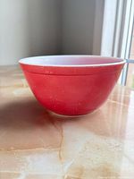 Side view showing red exterior finish and wear