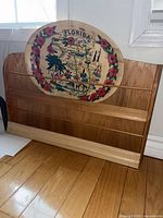 Wood wall shelf with Florida dish resting against it