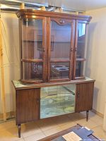 Full view of two-piece walnut veneer china cabinet hutch showing upper display and lower sideboard