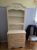 Full view of cream wooden hutch showing shelves and drawers