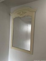 Front view of off-white framed mirror